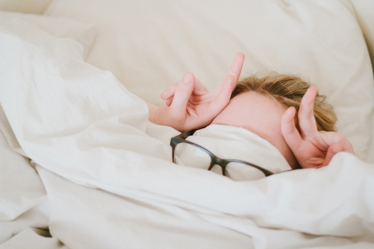 Girl in bed with glasses by Octave Zangs for Conscious by Chloé