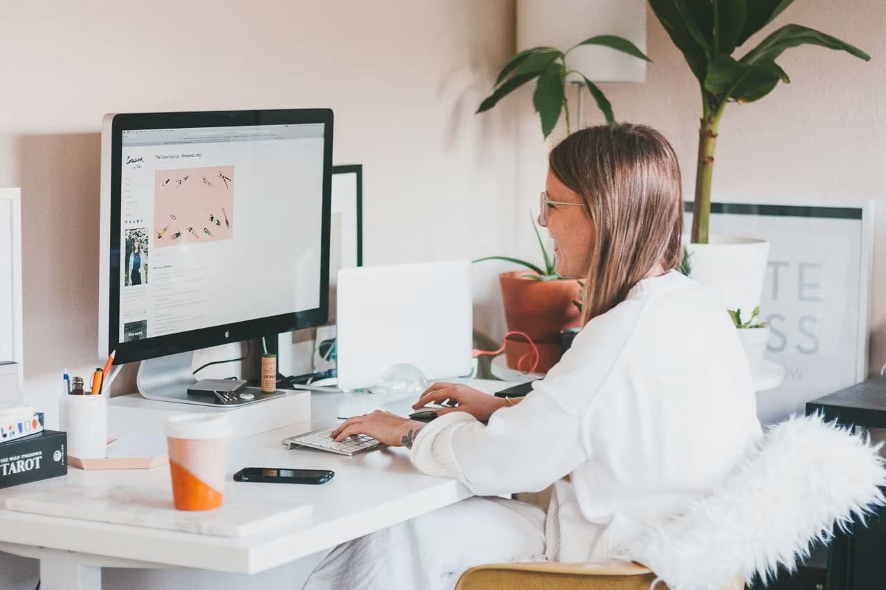 Person reviewing a website on a desktop computer in a clean workspace, representing digital presence and website audit work.